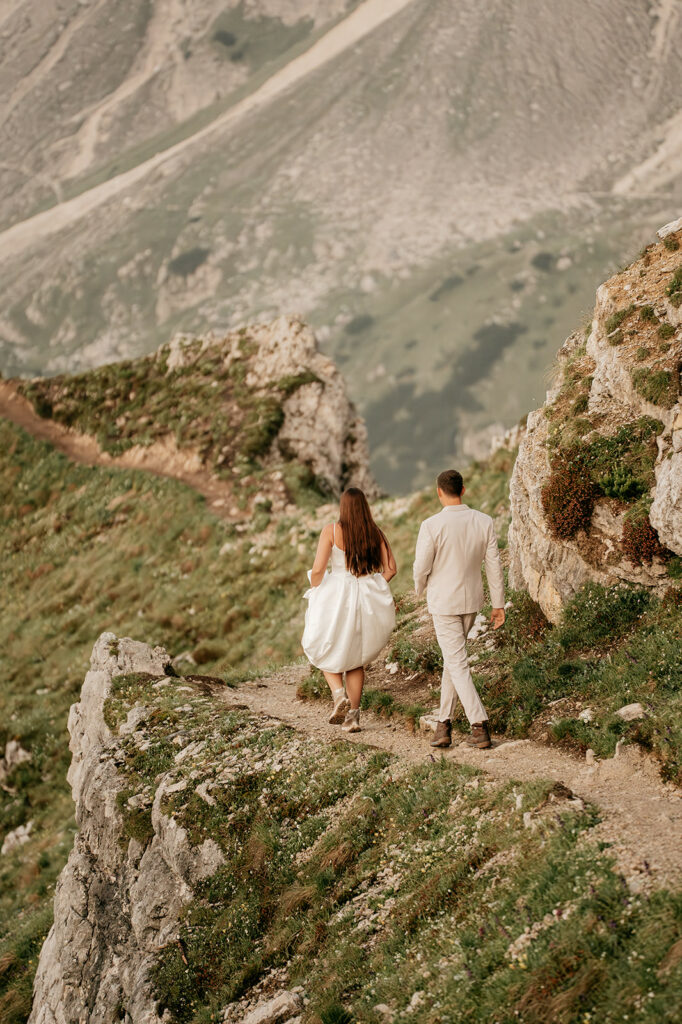 Couple hiking path on scenic mountain ridge