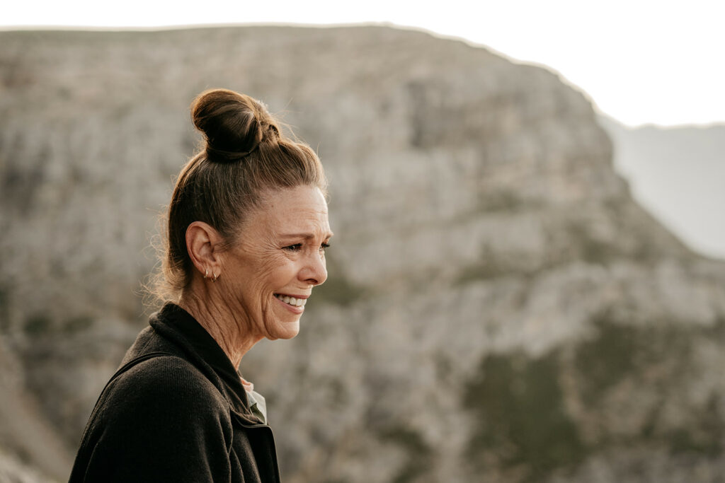 Smiling woman in front of mountain landscape