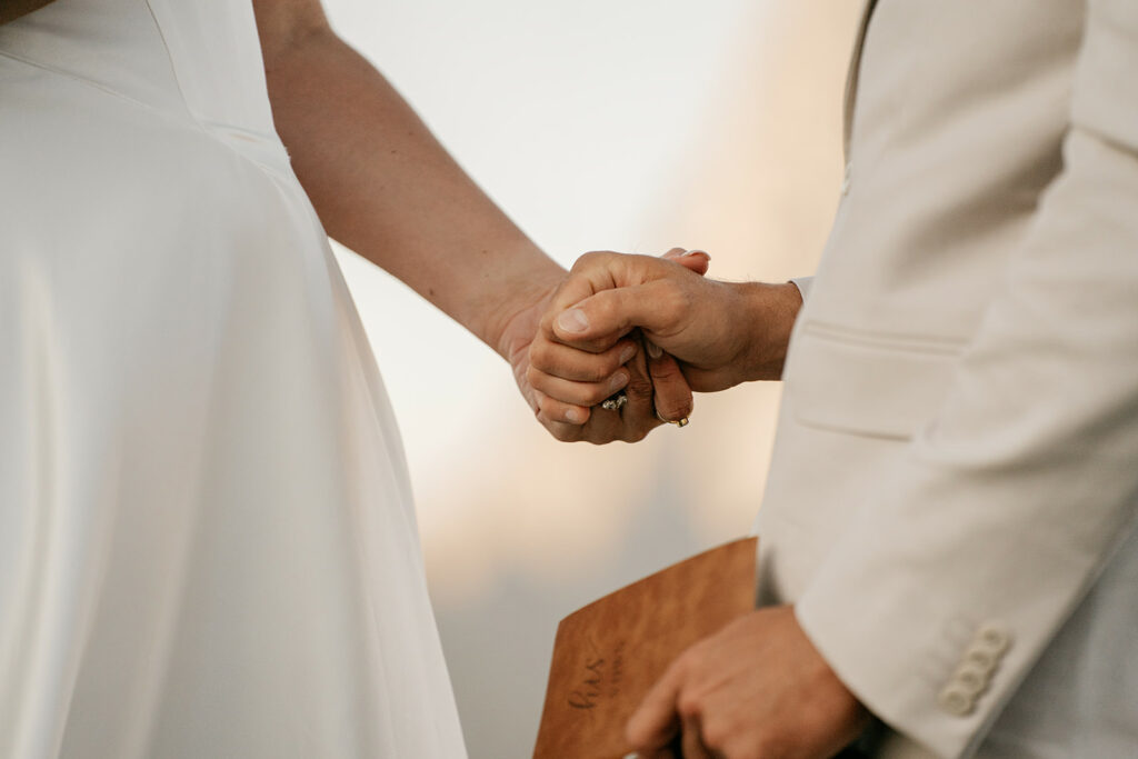 Couple holding hands at wedding ceremony