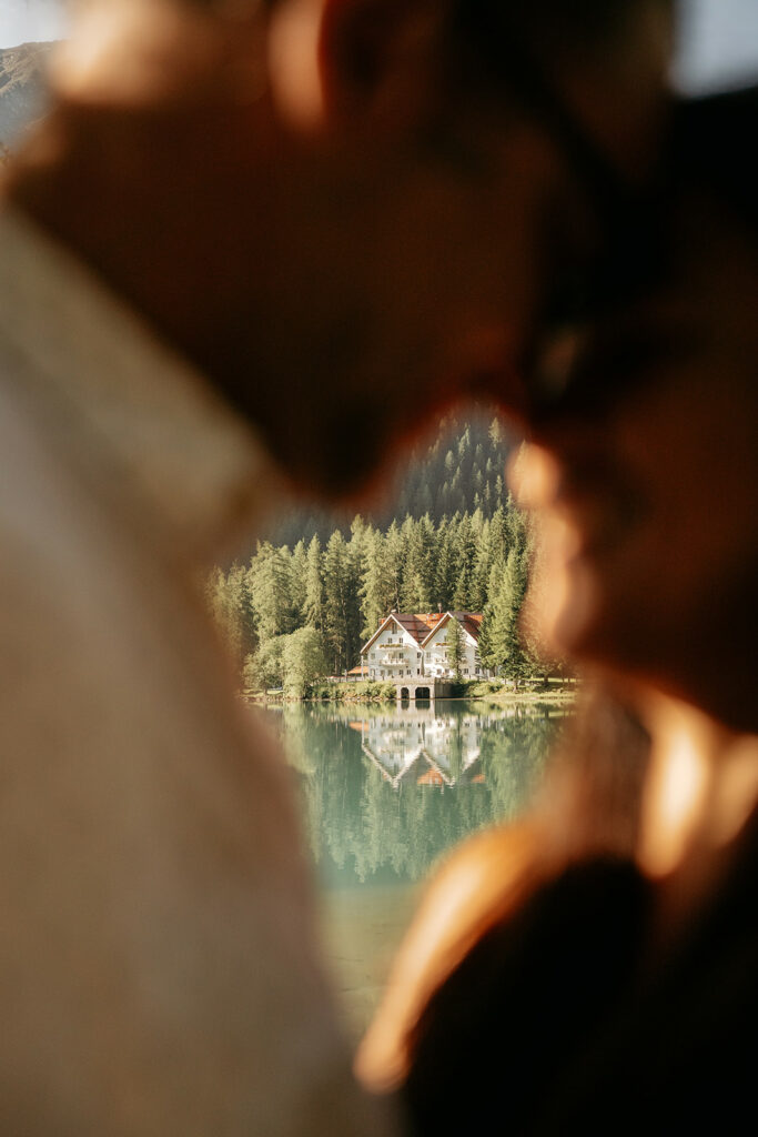 Cozy lake house surrounded by forest and mountains.