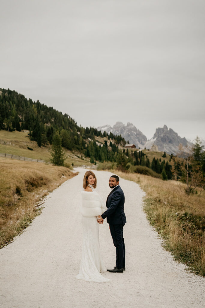 Bride and groom in scenic mountain setting.