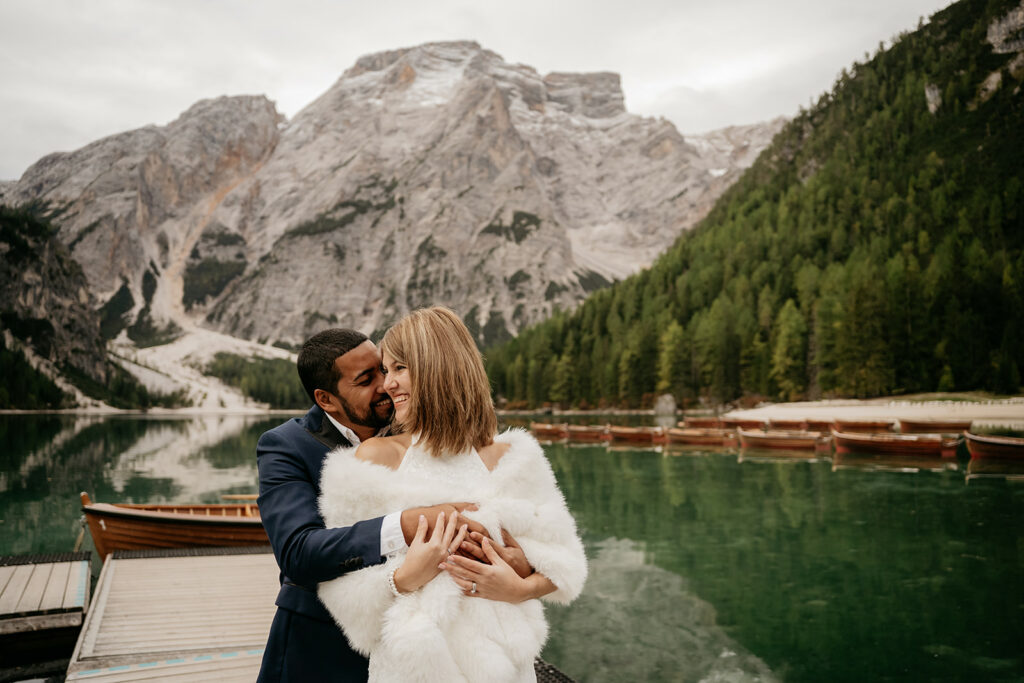 Couple embracing by scenic mountain lake