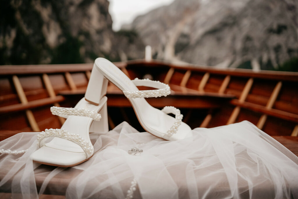 White pearl-embellished heels on boat deck.