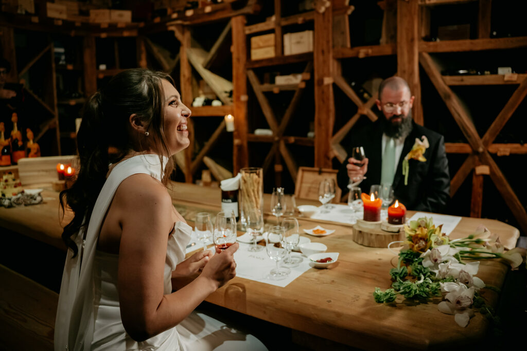 Couple enjoying wine in rustic cellar setting.
