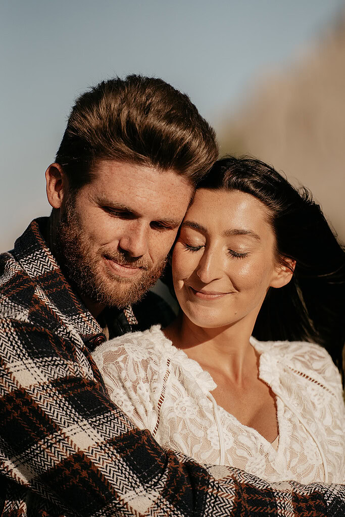 Happy couple embracing in sunlight