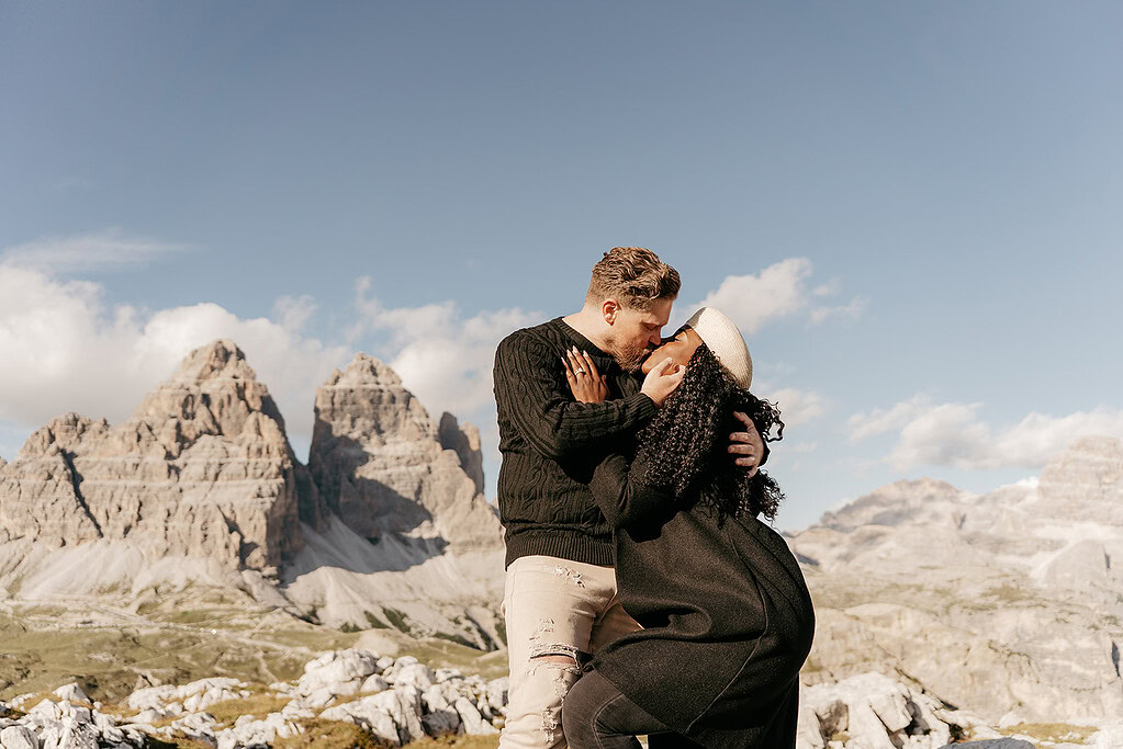 Couple kissing with mountain scenery background