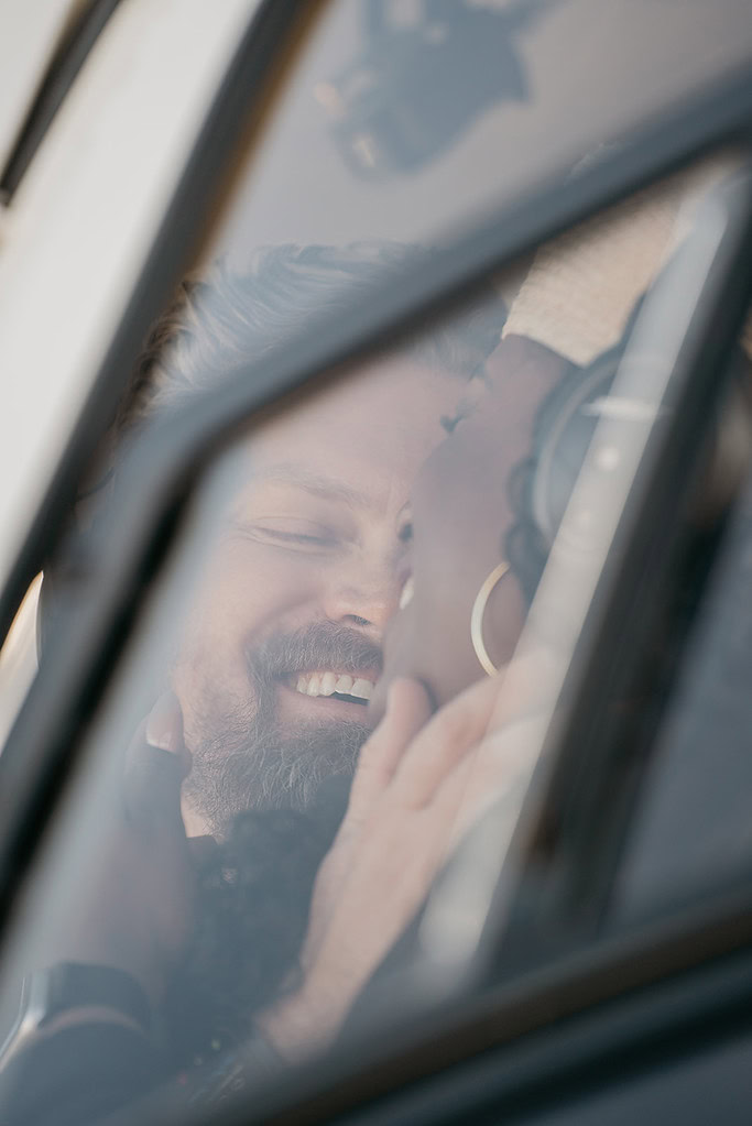 Close-up of couple smiling through window.