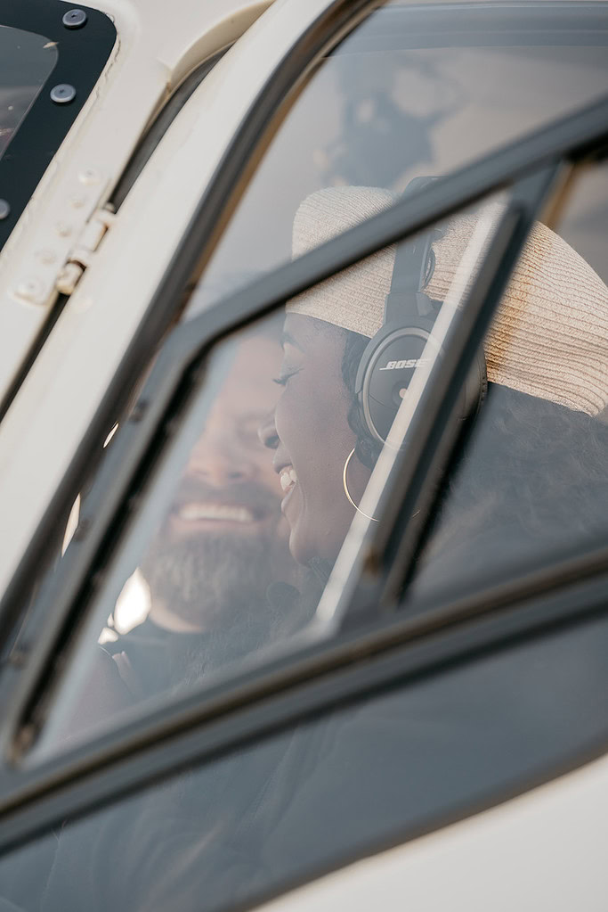 Two pilots smiling inside cockpit