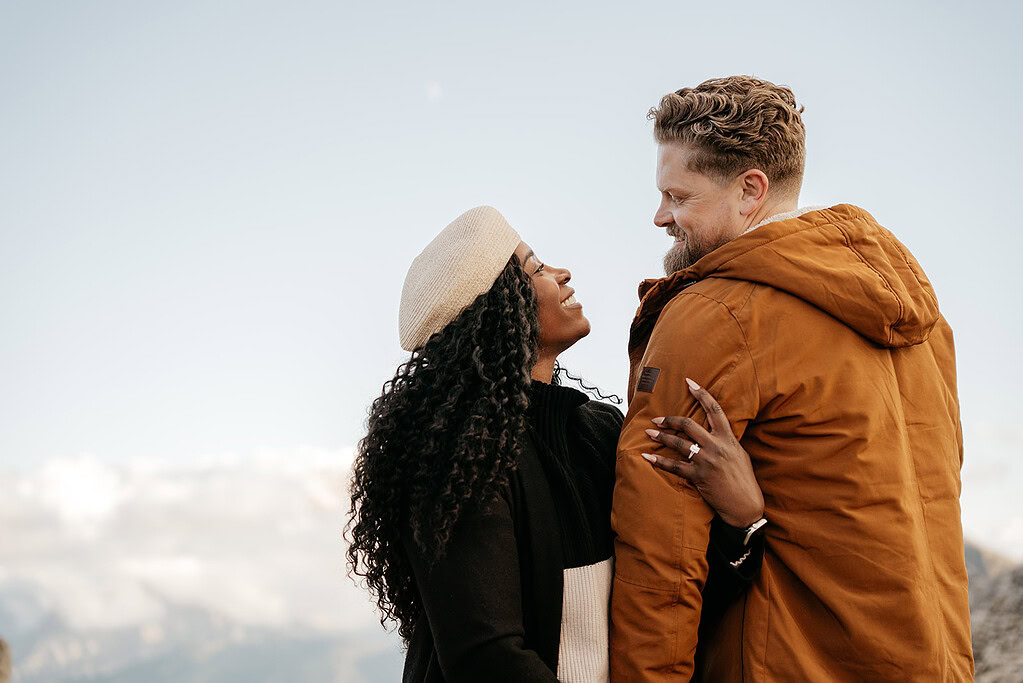 Smiling couple embracing outdoors, winter clothing