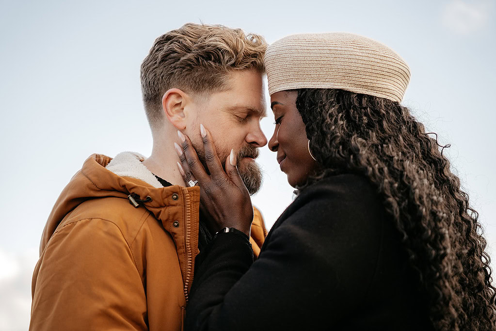 Couple embracing with closed eyes outdoors