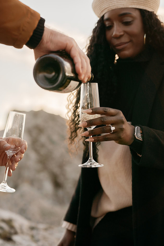 Pouring champagne into glasses at celebration