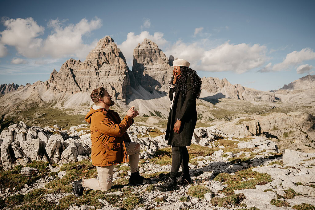 Man proposing marriage in mountain landscape