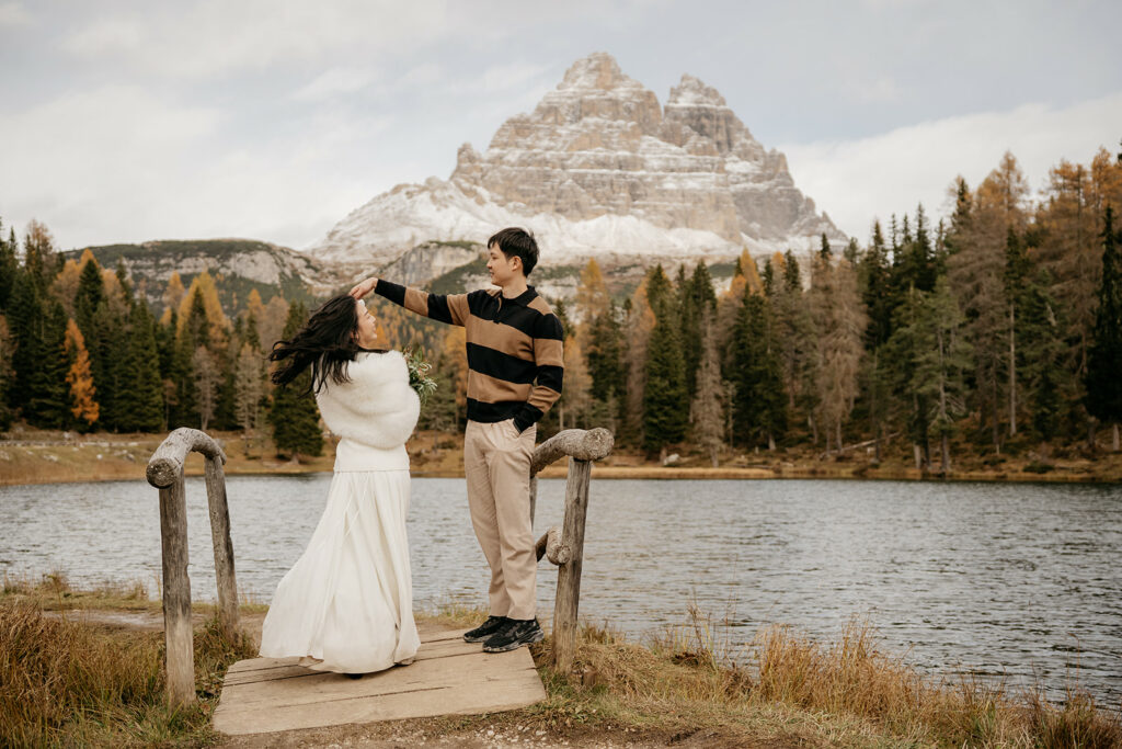 Couple by mountain and lake in autumn.