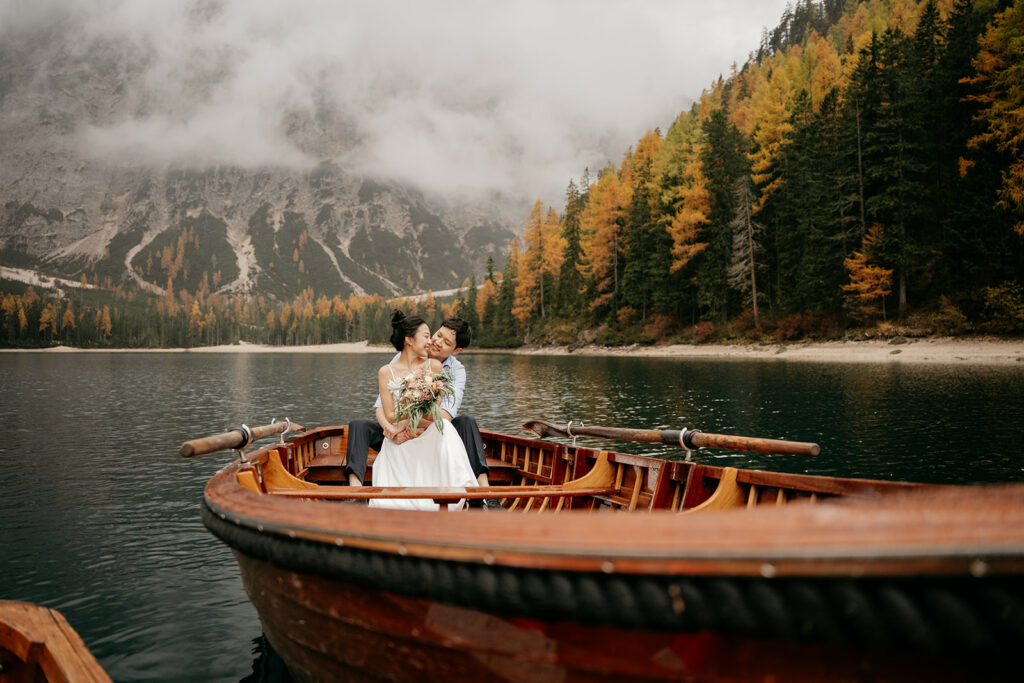 Couple in boat on scenic lake with mountains