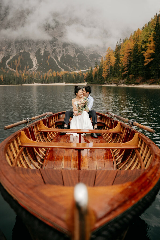 Couple embracing in boat on scenic lake