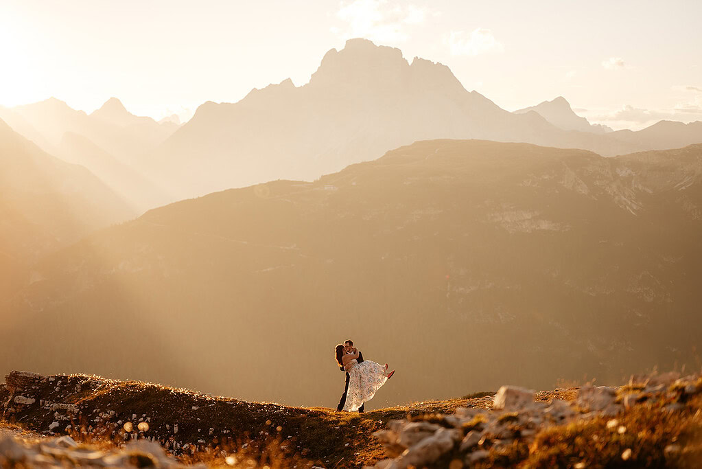 Couple embracing on mountain during sunset