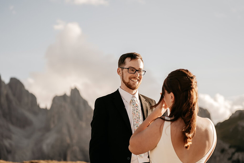 Bride and groom smiling in mountain landscape