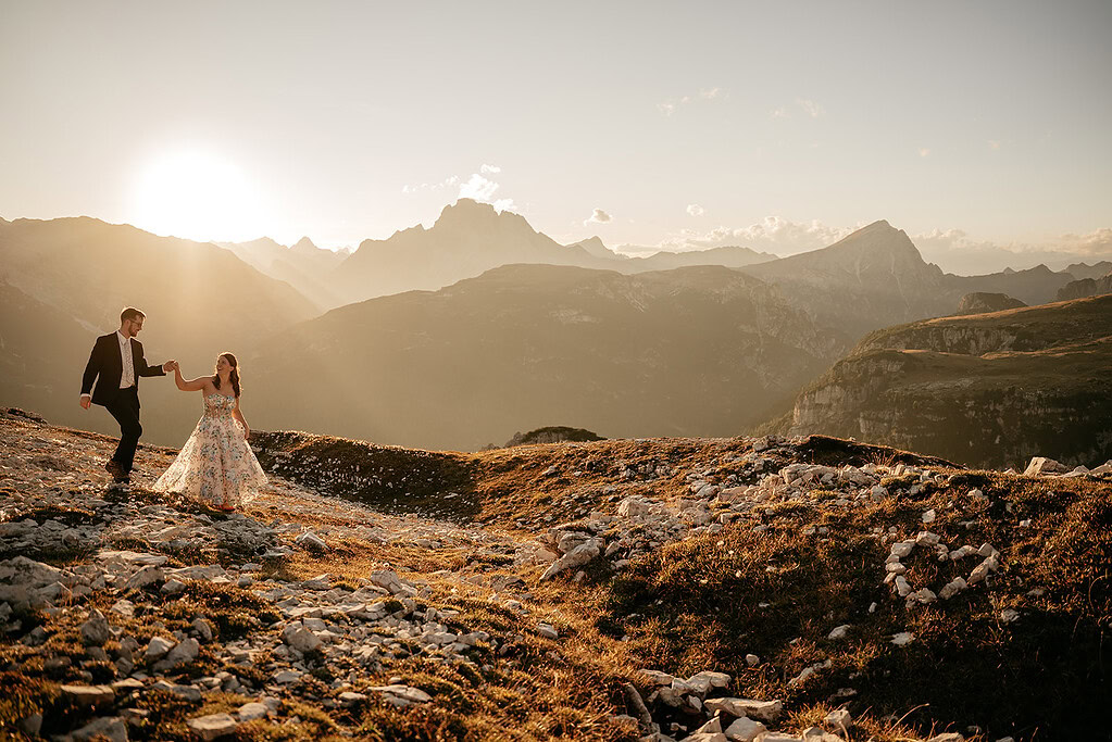 Couple walking on mountain at sunset
