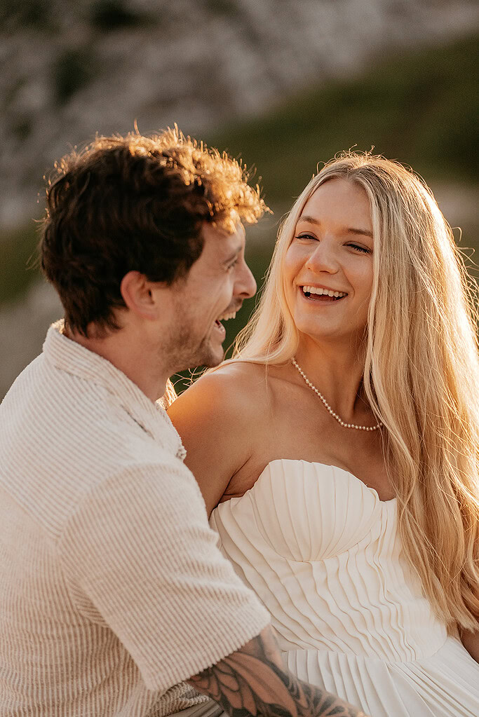 Couple laughing and enjoying a sunny day together.