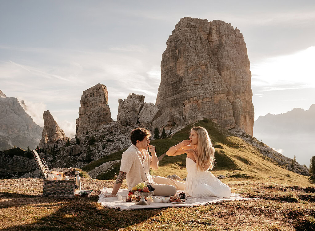 Couple enjoying picnic with mountain view