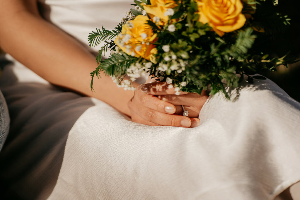 Bride holding bouquet with yellow roses