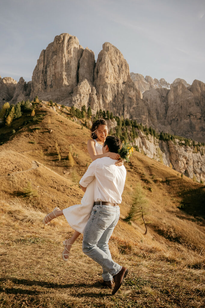 Couple enjoying mountainous landscape together joyfully.
