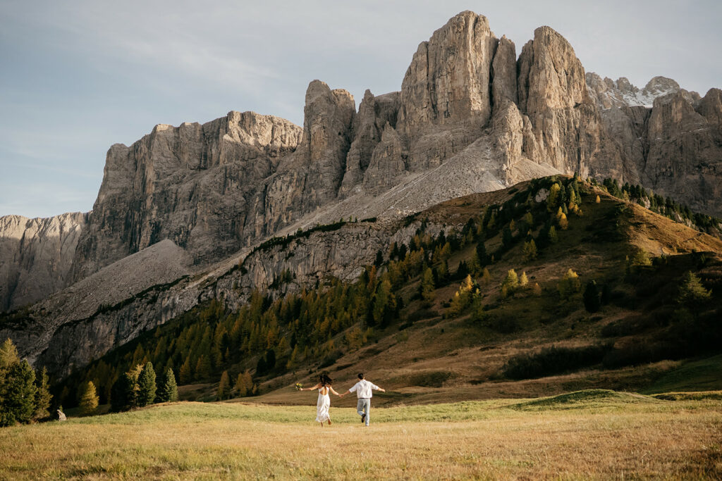 Couple running through scenic mountain landscape