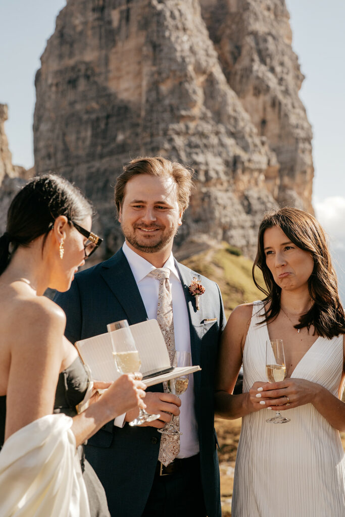 Outdoor wedding ceremony with mountainous backdrop.