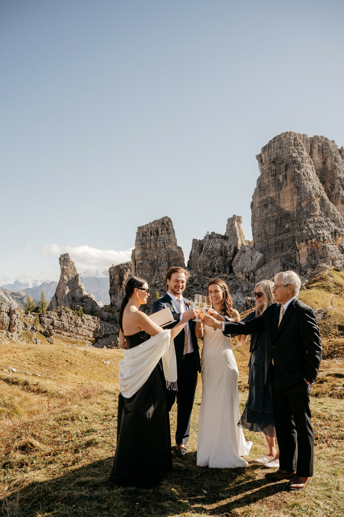 Group toasting at mountain wedding ceremony.
