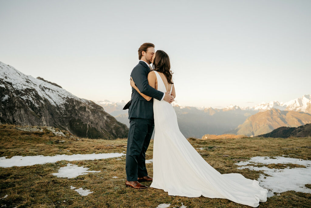 Couple kissing in mountain wedding scene