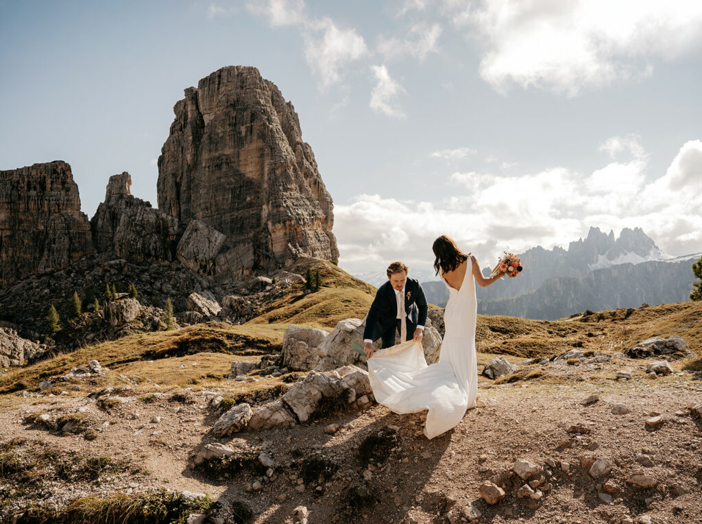 Couple celebrates wedding in scenic mountain landscape.