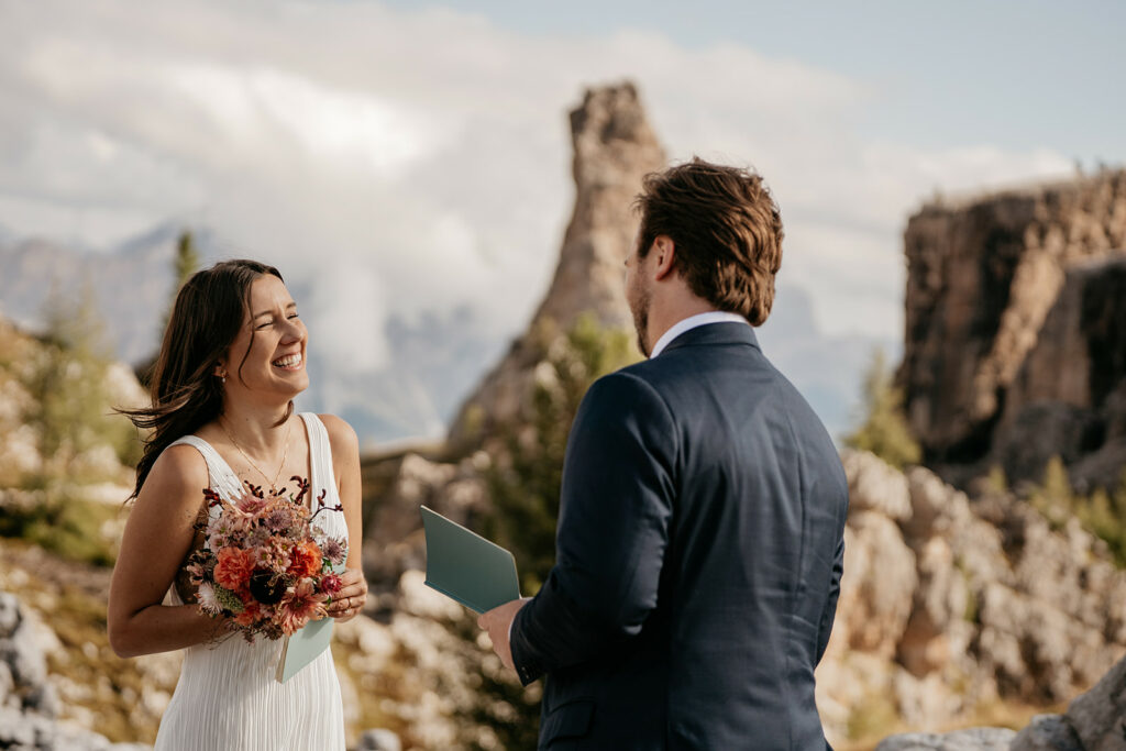 Couple exchanging vows in mountain setting.