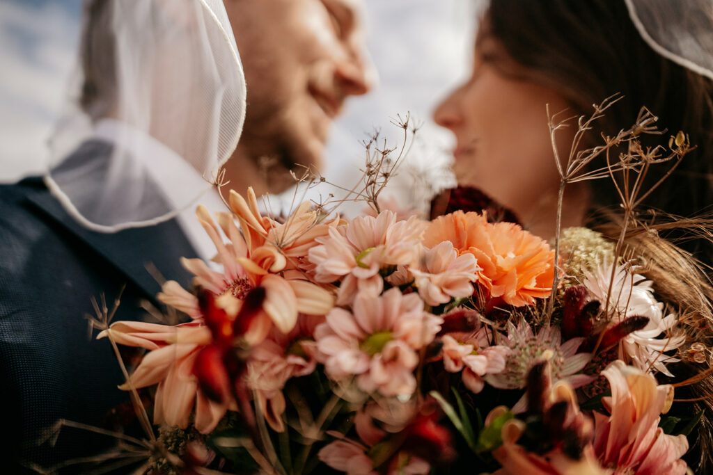 Wedding couple with bouquet of colorful flowers
