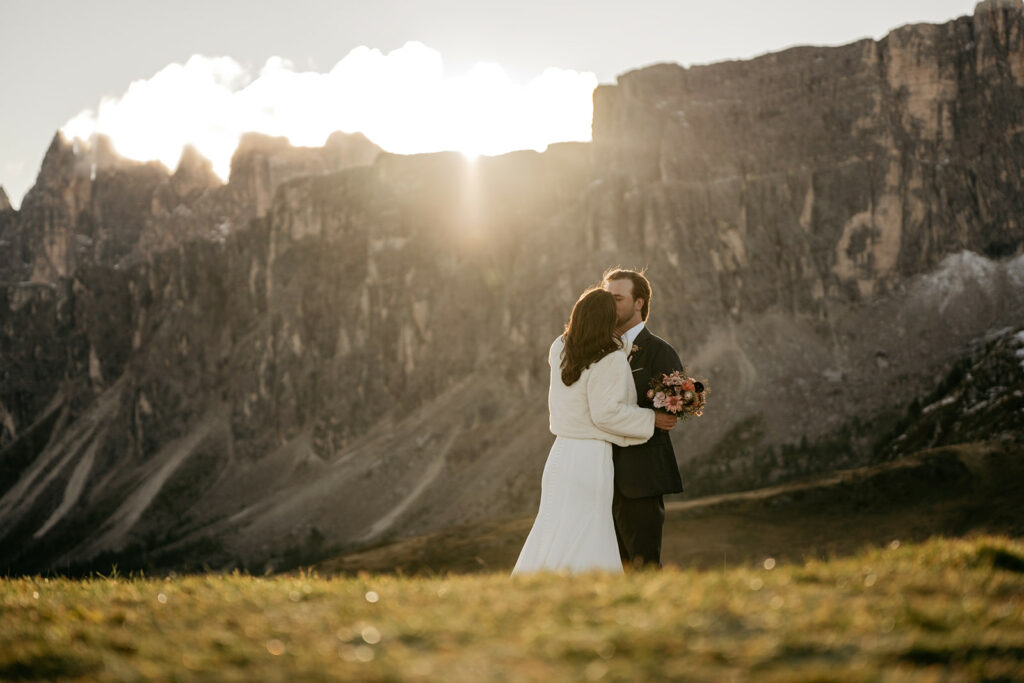 Couple kissing at sunset in mountainous landscape