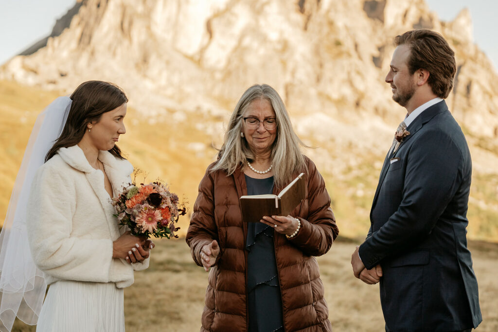 Outdoor wedding ceremony with officiant and couple