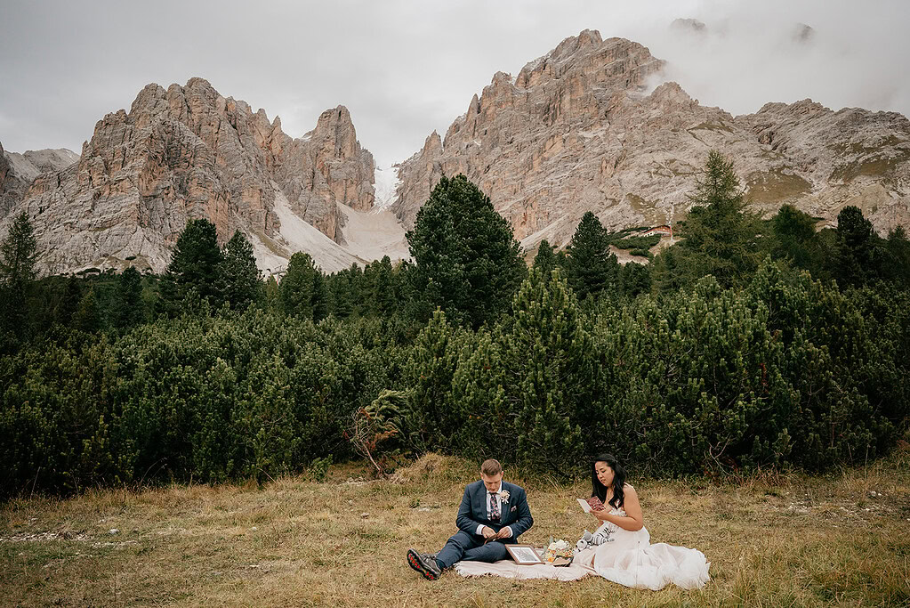 Couple sitting by mountains and trees