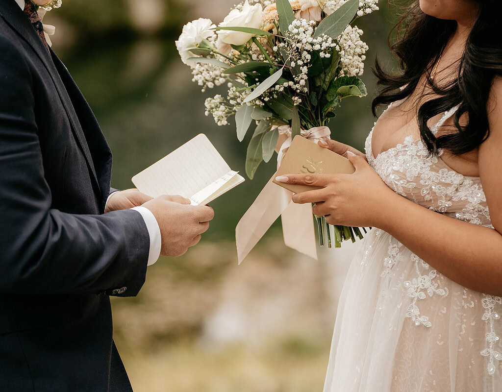 Couple exchanging vows at outdoor wedding ceremony.