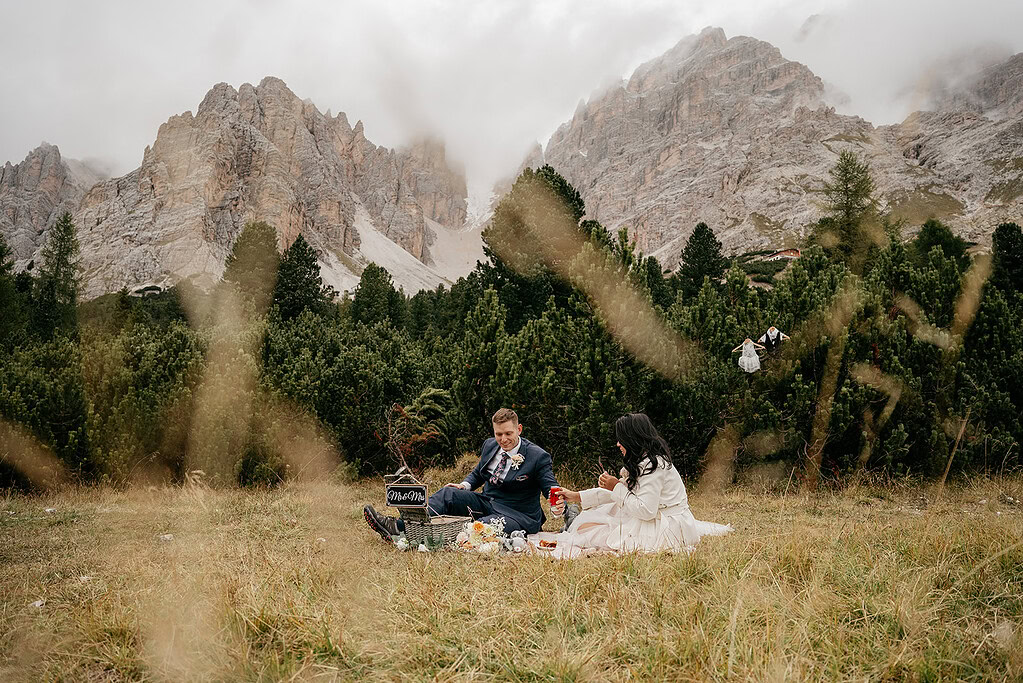 Couple picnic in picturesque mountain setting.