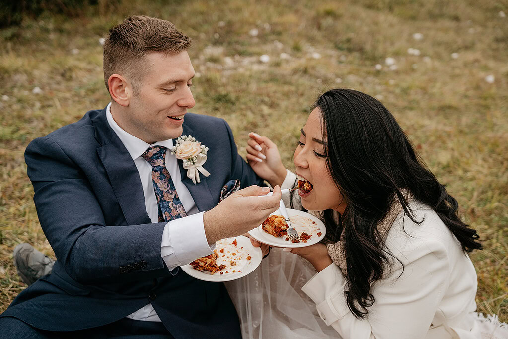 Couple enjoying picnic together outdoors.