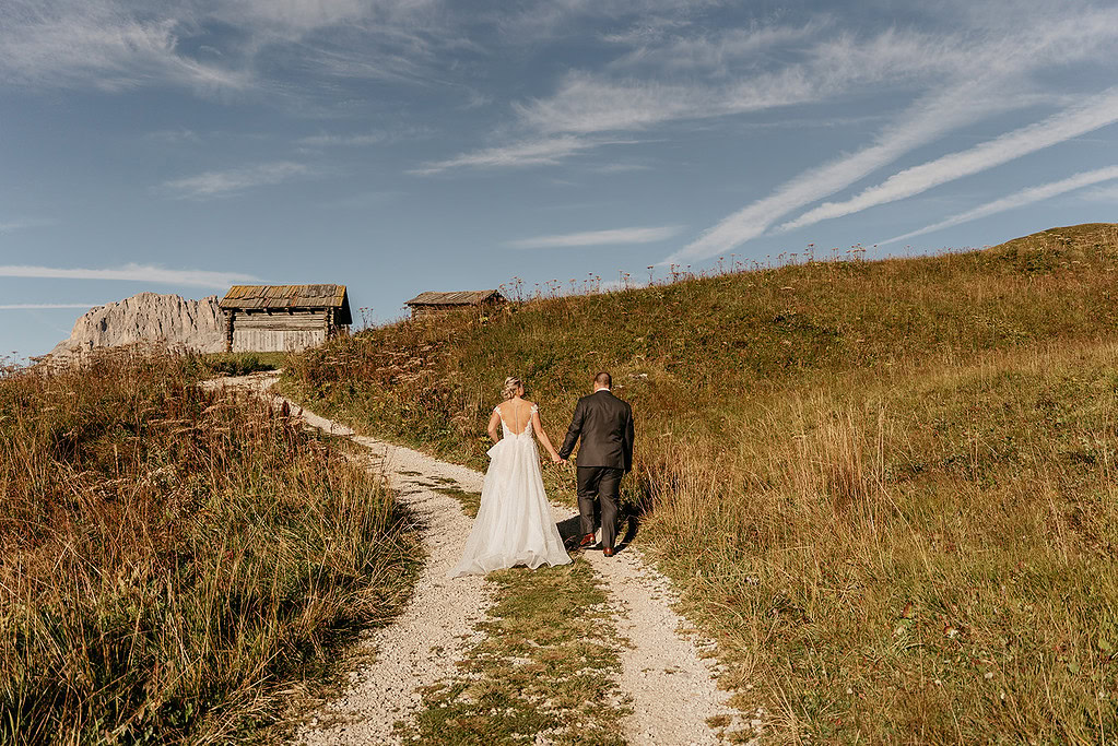 Bride and groom walking on rustic path