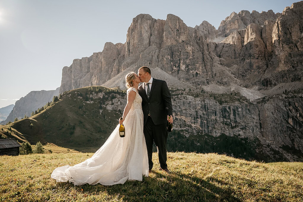 Wedding couple kissing in mountain landscape