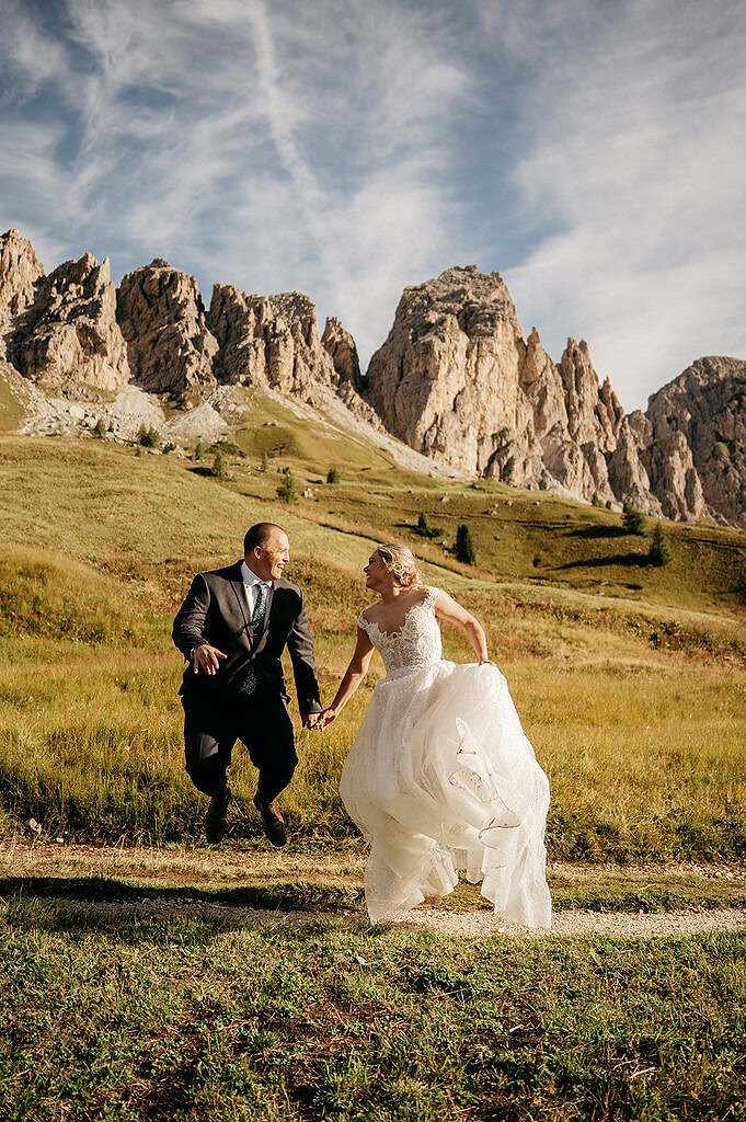 Couple jumping joyfully in mountain landscape