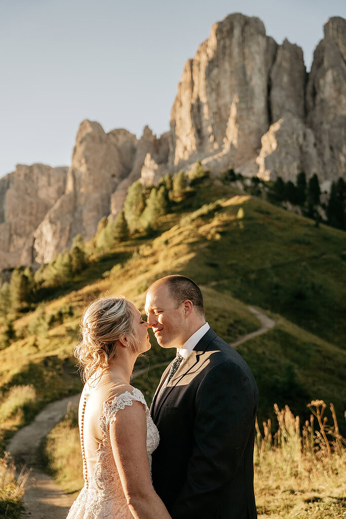 Couple embracing in mountain landscape at sunset.