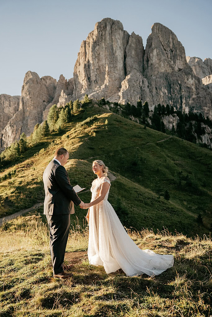Couple eloping in mountains at sunset.