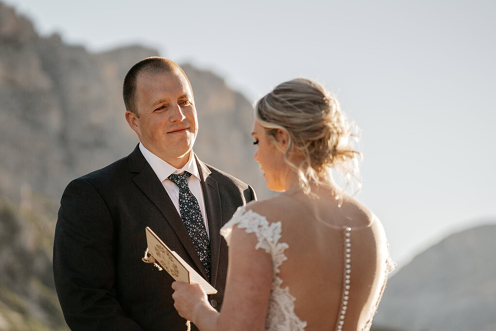 Couple exchanging vows outdoors at wedding